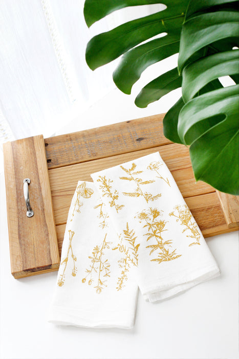 Wild Flower Tea Towel for the kitchen. A variety of golden wildflowers arranged on a white flour sack tea towel